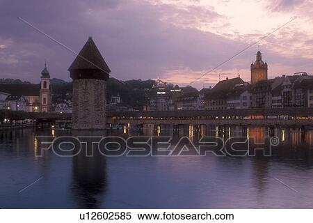 Lucerne, covered bridge, Switzerland, Luzern, Europe, The 14th century covered pedestrian bridge, the Kapellbrucke, on the Reuss in the evening in Lucerne is a picturesque landmark in the Canton of Lucerne. The octagonal stone tower alongside is called t View Large Photo Image Stock Photography - Lucerne, covered bridge, Switzerland, Luzern, Europe, The 14th century covered pedestrian bridge, the Kapellbrucke, on the Reuss in the evening in Lucerne is a picturesque landmark in the Canton of Lucerne. The octagonal stone tower alongside is called t. Fotosearch