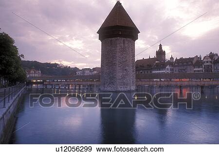 Luzern, covered bridge, Switzerland, Lucerne, Europe, The 14th century covered pedestrian bridge, the Kapellbrucke, on the Reuss in the evening in Lucerne is a picturesque landmark in the Canton of Lucerne. The octagonal stone tower alongside is called t View Large Photo Image Stock Photo - Luzern, covered bridge, Switzerland, Lucerne, Europe, The 14th century covered pedestrian bridge, the Kapellbrucke, on the Reuss in the evening in Lucerne is a picturesque landmark in the Canton of Lucerne. The octagonal stone tower alongside is called t. Fotosearch