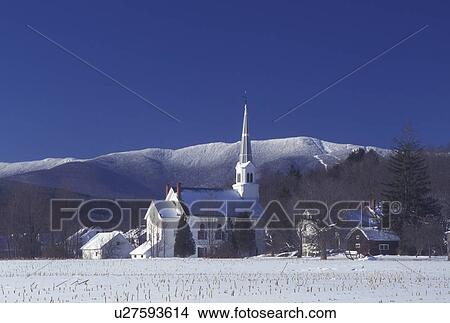 Picture -  Mad River, Vermont, church, VT, Scenic view of the United Church of Christ in the village of Waitsfield in the Mad River Valley with the snow-covered Green Mountains and Sugarbush Ski Area in the background in winter.. Fotosearch
