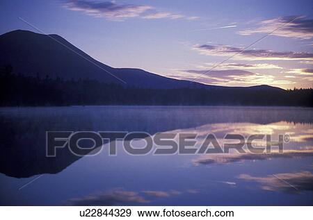 Maine, sunrise, sunset, lake, reflection, Baxter State Park, Mt. Katahdin reflects in the calm water of Daicey Pond at sunrise in the early morning in Baxter State Park. View Large Photo Image Stock Photo - Maine, sunrise, sunset, lake, reflection, Baxter State Park, Mt. Katahdin reflects in the calm water of Daicey Pond at sunrise in the early morning in Baxter State Park. . Fotosearch