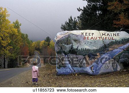 Maine, Young girl stands looking a beautiful painted rock Keep Maine Beautiful next to a road in northern Maine in autumn at entrance of Baxter State Park. View Large Photo Image Stock Image - Maine, Young girl stands looking a beautiful painted rock Keep Maine Beautiful next to a road in northern Maine in autumn at entrance of Baxter State Park.. Fotosearch