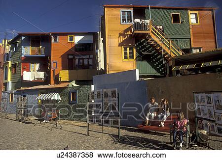 Stock Photo -  market, Buenos Aires, Argentina, Tango, Local artist's in Caminito (little street) display their work at an artist market in the district of La Boca in the capital city of Buenos Aires. Laundry hanging from brightly painted timber and corrugated iron pop. Fotosearch