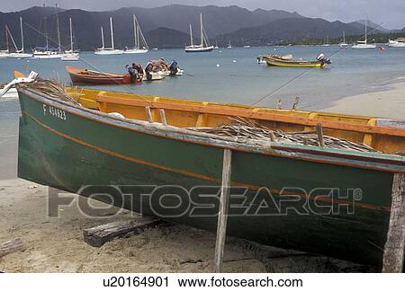 Stock Image -  Martinique, Caribbean, Caribbean Islands, Green fishing boat beached on the shore in Ste. Anne on the island of Martinique (a french department).. Fotosearch