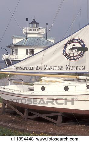 Stock Photo -  Maryland, Chesapeake Bay Maritime Museum, St. Michaels, Historic boat display and Hooper Strait Lighthouse at the Chesapeake Bay Maritime Museum in St. Michaels on the Chesapeake Bay in Maryland.. Fotosearch