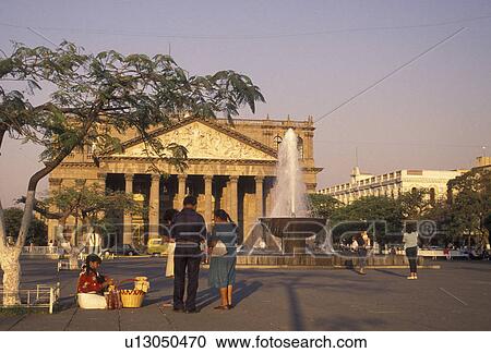 Mexico, Guadalajara, Degollado Theater, People buying goods from a street vendor at the Plaza de la Liberacion in downtown in front of the Degollado Theater (Teatro Degollado) in the city of Guadalajara in the state of Jalisco. View Large Photo Image Stock Image - Mexico, Guadalajara, Degollado Theater, People buying goods from a street vendor at the Plaza de la Liberacion in downtown in front of the Degollado Theater (Teatro Degollado) in the city of Guadalajara in the state of Jalisco.. Fotosearch
