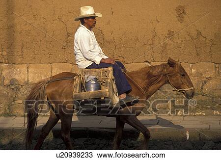Mexico, horse, Patzcuaro, Mexican man riding a horse carrying goods through the streets of Patzcuaro in the state of Michoacan. View Large Photo Image Stock Image - Mexico, horse, Patzcuaro, Mexican man riding a horse carrying goods through the streets of Patzcuaro in the state of Michoacan.. Fotosearch