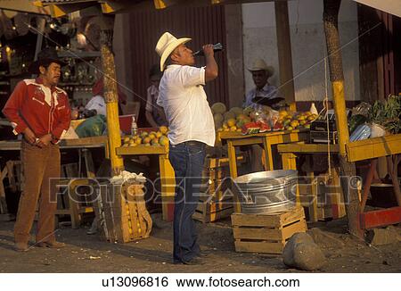 Mexico, market, Patzcuaro, Mexican men standing in front of an open air market in the city of Patzcuaro in the state of Michoacan. One man with a cowboy hat is drinking a bottle of coke. View Large Photo Image Stock Photograph - Mexico, market, Patzcuaro, Mexican men standing in front of an open air market in the city of Patzcuaro in the state of Michoacan. One man with a cowboy hat is drinking a bottle of coke.. Fotosearch