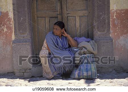 Mexico, people, San Miguel de Allende, A woman with black hair wearing a blue shaw sits in a doorway away from the hot sun in San Miguel de Allende in the state of Guanajuato. View Large Photo Image Stock Photo - Mexico, people, San Miguel de Allende, A woman with black hair wearing a blue shaw sits in a doorway away from the hot sun in San Miguel de Allende in the state of Guanajuato.. Fotosearch