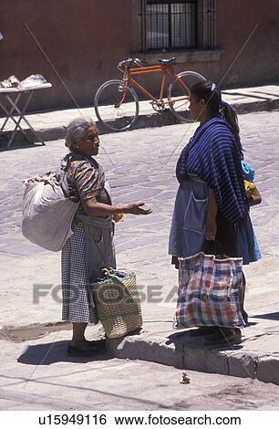 Mexico, people, San Miguel de Allende, Two women carrying large colorful bags talking together on the street in San Miguel de Allende in the state of Guanajuato. View Large Photo Image Stock Photograph - Mexico, people, San Miguel de Allende, Two women carrying large colorful bags talking together on the street in San Miguel de Allende in the state of Guanajuato.. Fotosearch