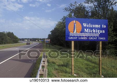 Stock Image -  Michigan, A welcome sign on the highway welcomes visitors to the state of Michigan.. Fotosearch