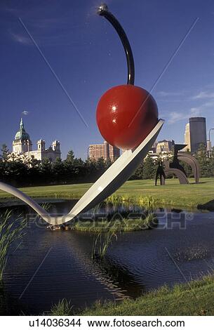Picture -  Minneapolis, cherry, spoon, Twin Cities, Minnesota, Spoonbridge and Cherry Sculpture in the Minneapolis Sculpture Garden at the Walker Art Center with the skyline of downtown Minneapolis in the state of Minnesota.. Fotosearch