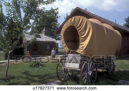 Stock Image -  Minnesota, Walnut Grove, A covered wagon is displayed at the Laura Ingalls Wilder Museum in Walnut Grove., . Fotosearch