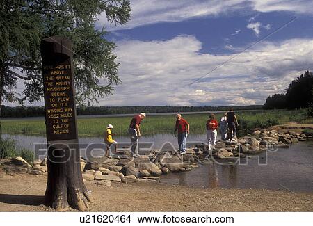 Mississippi River, headwaters, Itasca Park, Minnesota, People walking across the Mississippi River on rocks at the headwaters of the river in Itasca State Park in the state of Minnesota. View Large Photo Image Picture - Mississippi River, headwaters, Itasca Park, Minnesota, People walking across the Mississippi River on rocks at the headwaters of the river in Itasca State Park in the state of Minnesota.. Fotosearch