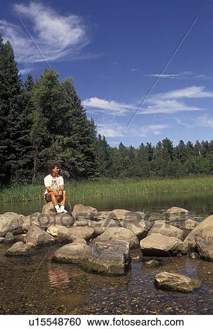 Mississippi River, headwaters, Itasca Park, Minnesota, Woman sitting on rocks at the headwaters of the Mississippi River in Itasca State Park in the state of Minnesota. View Large Photo Image Stock Image -  Mississippi River, headwaters, Itasca Park, Minnesota, Woman sitting on rocks at the headwaters of the Mississippi River in Itasca State Park in the state of Minnesota.. Fotosearch