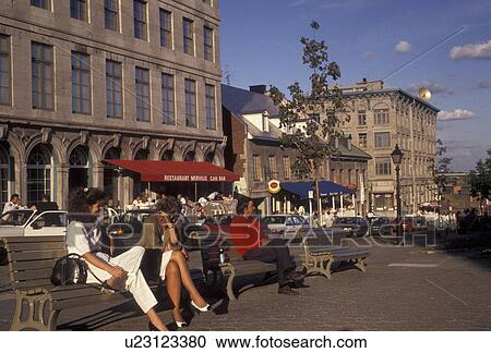 Stock Image -  Montreal, Quebec, Canada, People sitting on benches in Place Jacques-Cartier in Old Montreal (Vieux Montreal) in the Province of Quebec, Canada.. Fotosearch