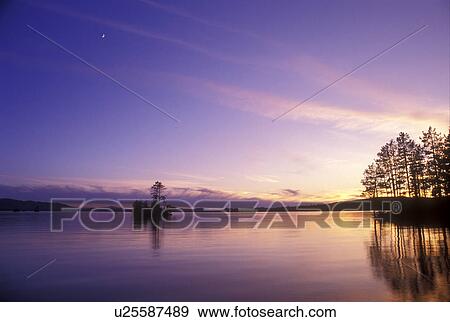 Moosehead Lake, Lake Region, Maine, (Sunset, sunrise) over the calm Moosehead Lake shows the refection of trees in the water. View Large Photo Image Stock Photo - Moosehead Lake, Lake Region, Maine, (Sunset, sunrise) over the calm Moosehead Lake shows the refection of trees in the water.. Fotosearch