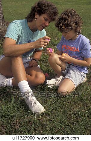 mother, child, easter, eggs, Mother and 6 year old daughter breaking and looking at colored Easter Eggs while sitting on the lawn in a park on a warm spring day. View Large Photo Image Stock Image - mother, child, easter, eggs, Mother and 6 year old daughter breaking and looking at colored Easter Eggs while sitting on the lawn in a park on a warm spring day.. Fotosearch