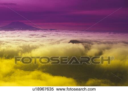Mount Adams, volcano, fog, Cascades, Cascade Range, Washington, View of the summit of Mount Adams through the fog from Mount St. Helens National Volcanic Monument in the state of Washington. (purple/yellow filter) View Large Photo Image Stock Photography - Mount Adams, volcano, fog, Cascades, Cascade Range, Washington, View of the summit of Mount Adams through the fog from Mount St. Helens National Volcanic Monument in the state of Washington. (purple/yellow filter) . Fotosearch