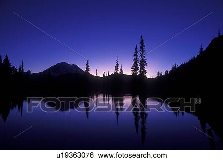 Mount Rainier, mirror, Mt. Rainier National Park, Cascades, Cascade Range, Washington, Silhouette of Mt. Rainier at sunset reflecting in a mountain pond at Chinook Pass in the Cascade Mountain Range in Mount Rainier Nat'l Park in the state of Washington. View Large Photo Image Stock Photograph - Mount Rainier, mirror, Mt. Rainier National Park, Cascades, Cascade Range, Washington, Silhouette of Mt. Rainier at sunset reflecting in a mountain pond at Chinook Pass in the Cascade Mountain Range in Mount Rainier Nat'l Park in the state of Washington.. Fotosearch
