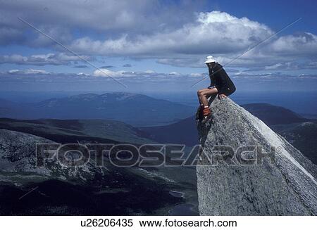 Stock Photography -  mountain, summit, Mt. Katahdin, Baxter State Park, Maine, Man on a rock outcrop on Dudley Trail. Scenic view of the mountains in the background.. Fotosearch