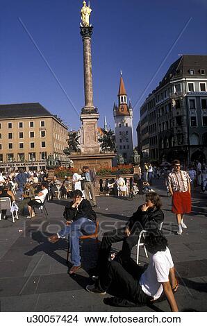 Munich, Germany, plaza, Bavaria, Europe, People relaxing around the Marienplatz in Munich. Column of Madonna stands erect in the middle of the plaza in downtown Munich. View Large Photo Image Picture - Munich, Germany, plaza, Bavaria, Europe, People relaxing around the Marienplatz in Munich. Column of Madonna stands erect in the middle of the plaza in downtown Munich.. Fotosearch