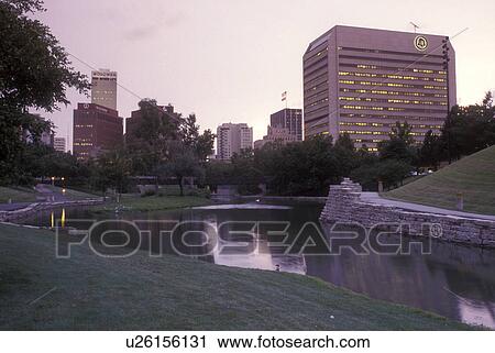 Stock Image -  Nebraska, Skyline of downtown Omaha in the evening from the Gene Leahy Mall.. Fotosearch
