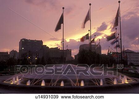 Stock Photo -  Nebraska, The fountain lights up in front of the Con-Agra Co. at [sunrise, sunset] in Omaha . Fotosearch