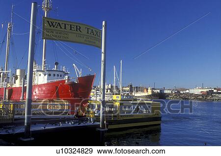 New Jersey, Jersey City, Liberty State Park, A yellow water taxi docked on Upper New York Bay ready to pick up passengers to Manhattan, New York. A red craft is docked in background. View Large Photo Image Stock Photo - New Jersey, Jersey City, Liberty State Park, A yellow water taxi docked on Upper New York Bay ready to pick up passengers to Manhattan, New York. A red craft is docked in background.. Fotosearch