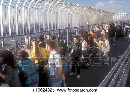 New York City, Empire State Building, Manhattan, New York, N. Y. C Tourists viewing New York City, New York from the outdoor Observation Deck of the Empire State Building in Midtown Manhattan. View Large Photo Image Stock Photography - New York City, Empire State Building, Manhattan, New York, N. Y. C Tourists viewing New York City, New York from the outdoor Observation Deck of the Empire State Building in Midtown Manhattan.. Fotosearch