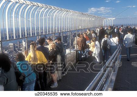 New York City, Empire State Building, Manhattan, New York, N. Y. C Tourists viewing New York City, New York from the outdoor Observation Deck of the Empire State Building in Midtown Manhattan. View Large Photo Image Stock Photography - New York City, Empire State Building, Manhattan, New York, N. Y. C Tourists viewing New York City, New York from the outdoor Observation Deck of the Empire State Building in Midtown Manhattan.. Fotosearch