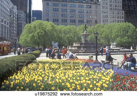 Stock Image -  New York City, Manhattan, New York, N. Y. C Colorful spring flowers adorn Grand Army Plaza and Pulitzer Fountain across from The Plaza Hotel in Midtown Manhattan in New York City, New York. . Fotosearch