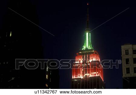 New York City, Manhattan, New York, The Christmas lights of red and green illuminate the Empire State Building in Midtown Manhattan at night (evening). View Large Photo Image Stock Photo -  New York City, Manhattan, New York, The Christmas lights of red and green illuminate the Empire State Building in Midtown Manhattan at night (evening).. Fotosearch