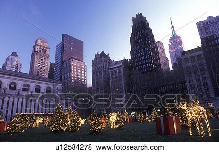 New York City, Manhattan, New York, Christmas lights decorate the park in front of the Empire State Building in Mid town Manhattan at night (evening). View Large Photo Image Stock Photo - New York City, Manhattan, New York, Christmas lights decorate the park in front of the Empire State Building in Mid town Manhattan at night (evening).. Fotosearch