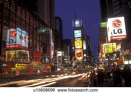 Stock Photograph -  New York City, Manhattan, New York, Time Square illuminated at night, evening along Broadway in Midtown Manhattan.. Fotosearch