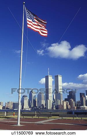 New York City, New York, A view of the skyline of downtown Manhattan and New York Harbor. The American Flag flies over Liberty Sate Park, NJ. View Large Photo Image Stock Photo - New York City, New York, A view of the skyline of downtown Manhattan and New York Harbor. The American Flag flies over Liberty Sate Park, NJ.. Fotosearch