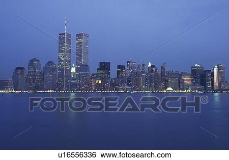 New York City, New York, Manhattan, The illuminated skyline of Manhattan reflects in the waters of the New York Harbor at night (evening). View Large Photo Image Stock Photograph - New York City, New York, Manhattan, The illuminated skyline of Manhattan reflects in the waters of the New York Harbor at night (evening).. Fotosearch