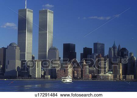 New York City, New York, The skyline of downtown Manhattan rises above the New York Harbor as the Statue of Liberty Passenger Ferry cruises by View Large Photo Image Picture - New York City, New York, The skyline of downtown Manhattan rises above the New York Harbor as the Statue of Liberty Passenger Ferry cruises by . Fotosearch