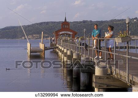 Picture -  New York, Finger Lakes, Family standing on the Watkin's Glen Public Pier on Seneca Lake in Watkins Glen., . Fotosearch