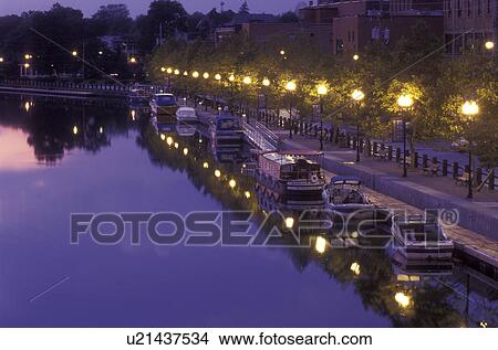 New York, Seneca Falls, Finger Lakes, Boats along Cayuga-Seneca Canal reflects in the calm evening water. View Large Photo Image Picture - New York, Seneca Falls, Finger Lakes, Boats along Cayuga-Seneca Canal reflects in the calm evening water.. Fotosearch