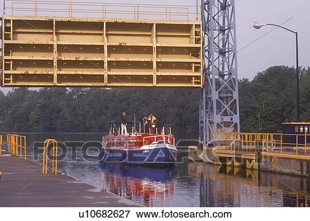 New York, Seneca Falls, Finger Lakes, Cayuga-Seneca Canal. A red, white and blue cruise line boat coasts into double lock, 49 feet drop. View Large Photo Image Stock Photo - New York, Seneca Falls, Finger Lakes, Cayuga-Seneca Canal. A red, white and blue cruise line boat coasts into double lock, 49 feet drop.. Fotosearch