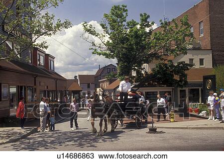Stock Image -  Newport, horse-drawn carriage, The Mooring, Rhode Island, Newport Harbor, Horse drawn carriage ride takes tourists through Bowen's Wharf at Newport's colonial seaport in the state of Rhode Island. . Fotosearch