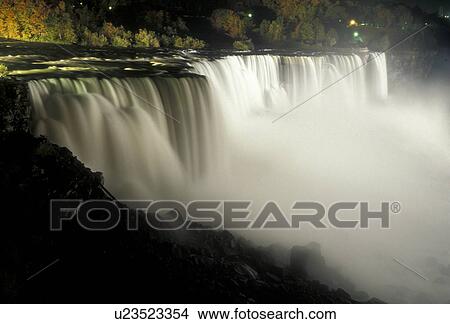 Niagara Falls, waterfall, New York, Scenic view of the American Falls illuminated at night in Niagara Falls in the state of New York. View Large Photo Image Picture - Niagara Falls, waterfall, New York, Scenic view of the American Falls illuminated at night in Niagara Falls in the state of New York.. Fotosearch