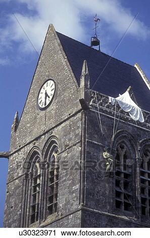 Normandy, France, Manche, Europe, A figure of the World War II paratrooper hangs from the church tower in Ste Mere Eglise. Sainte-Mere-Eglise was the first French town liberated on D-Day. View Large Photo Image Stock Image - Normandy, France, Manche, Europe, A figure of the World War II paratrooper hangs from the church tower in Ste Mere Eglise. Sainte-Mere-Eglise was the first French town liberated on D-Day.. Fotosearch