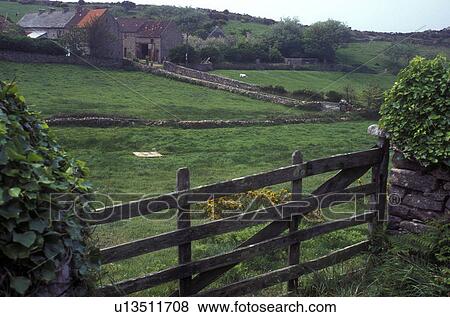 Stock Photo -  Normandy, France, Manche, Europe, An old farm with stonewalls surrounding the lush green pasture in Cap de la Hague.. Fotosearch
