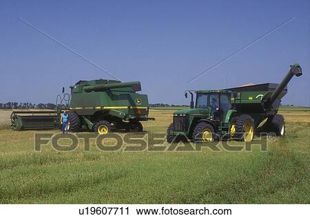 Stock Image -  North Dakota, harvest, Farm machinery harvesting a field of wheat in Richland County . Fotosearch