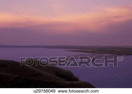 Stock Photo -  North Dakota, [Sunrise, sunset] over Lake Sakakawea and Four Bears Bridge at Fort Berthold Indian Reservation in New Town . Fotosearch