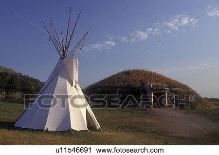 Stock Image -  North Dakota, Teepee and earth lodge are exhibited at On-a-Slant Mandan Indian Village at Fort Abraham Lincoln State Park in Mandan. . Fotosearch