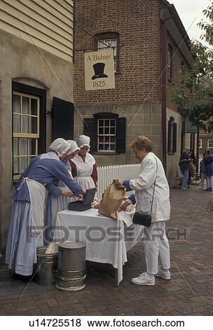 Old Salem, bakery, Winston-Salem, North Carolina, Women dressed in authentic costumes selling baked goods outside the Bakery in Old Salem a living history restoration of the Moravian Church town of Salem founded in 1766 in Winston-Salem in the state of N View Large Photo Image Stock Photo - Old Salem, bakery, Winston-Salem, North Carolina, Women dressed in authentic costumes selling baked goods outside the Bakery in Old Salem a living history restoration of the Moravian Church town of Salem founded in 1766 in Winston-Salem in the state of N. Fotosearch