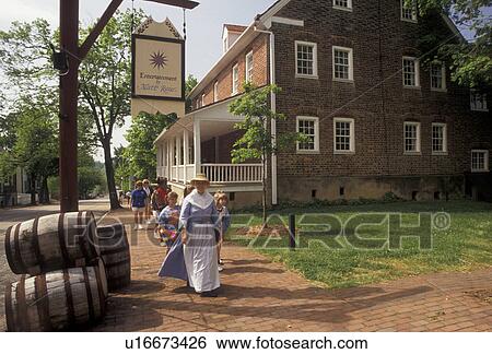 Old Salem, Moravian, Winston-Salem, North Carolina, A group of people walk with an interpreter along the streets of Old Salem, a living history restoration of the Moravian church town of Salem founded in 1766, in Winston-Salem in the state of North Carol View Large Photo Image Stock Photograph - Old Salem, Moravian, Winston-Salem, North Carolina, A group of people walk with an interpreter along the streets of Old Salem, a living history restoration of the Moravian church town of Salem founded in 1766, in Winston-Salem in the state of North Carol. Fotosearch