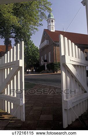 Old Salem, Moravian, Winston-Salem, North Carolina, Looking through the open white gates at the village of Old Salem, a living history restoration of the Moravian church town of Salem founded in 1766, in Winston-Salem in the state of North Carolina. View Large Photo Image Stock Photography - Old Salem, Moravian, Winston-Salem, North Carolina, Looking through the open white gates at the village of Old Salem, a living history restoration of the Moravian church town of Salem founded in 1766, in Winston-Salem in the state of North Carolina.. Fotosearch